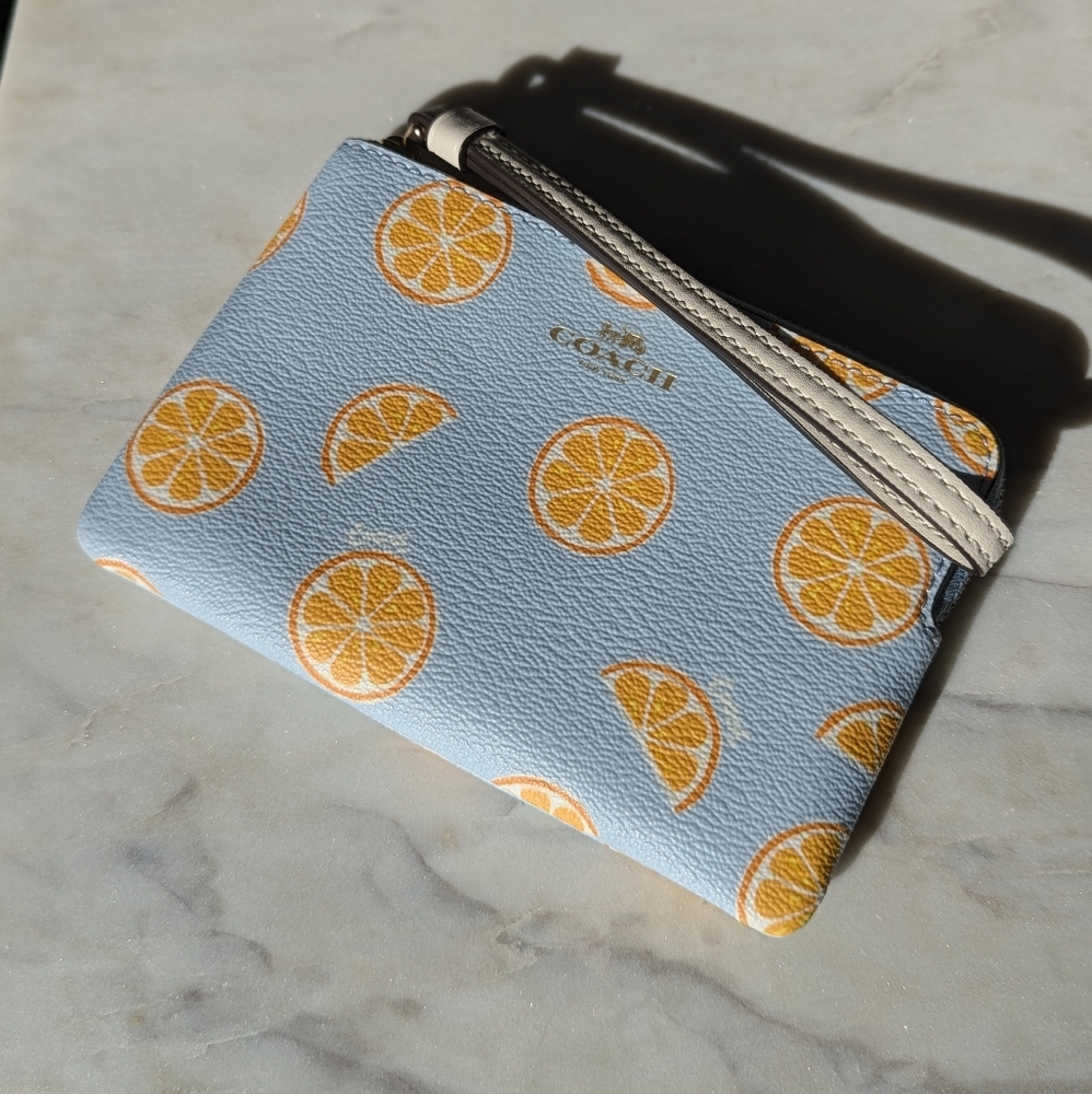COACH WRISTLET WITH ORANGE PRINT